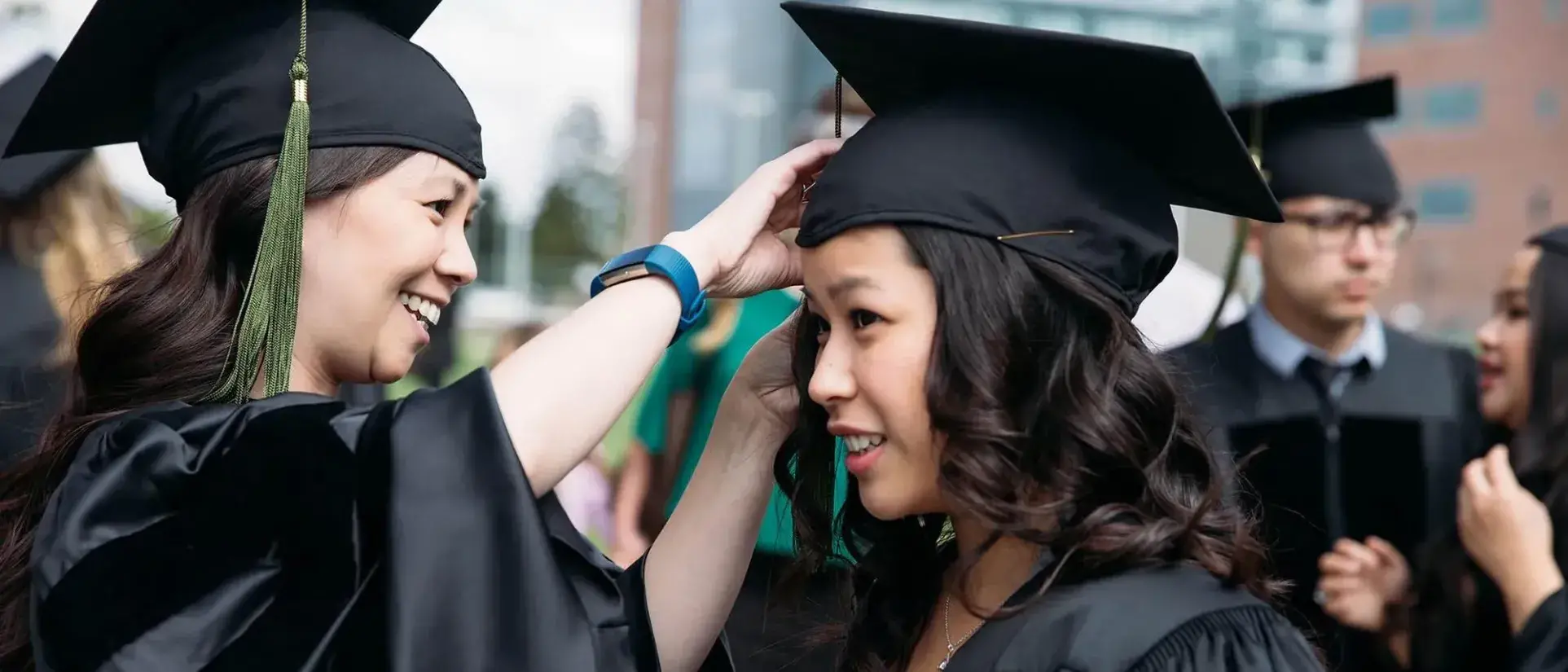 Graduates adjusting their caps