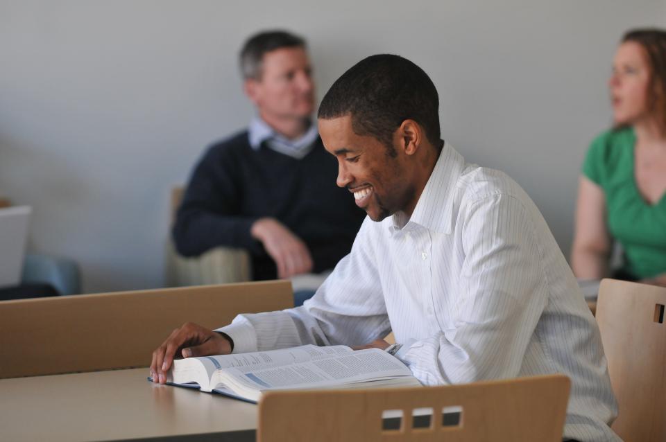 Student reading at desk