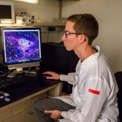 Student sits in front of computer in lab