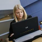 Student sits in front of laptop in class